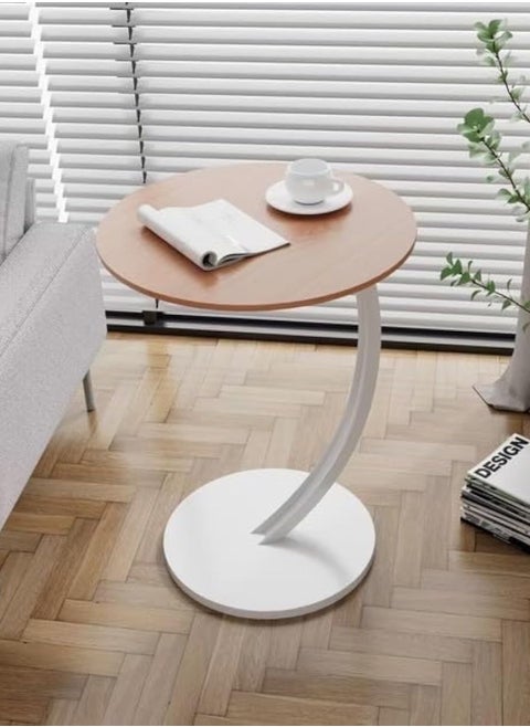 Small C-shaped double-layer side table next to the sofa and bed