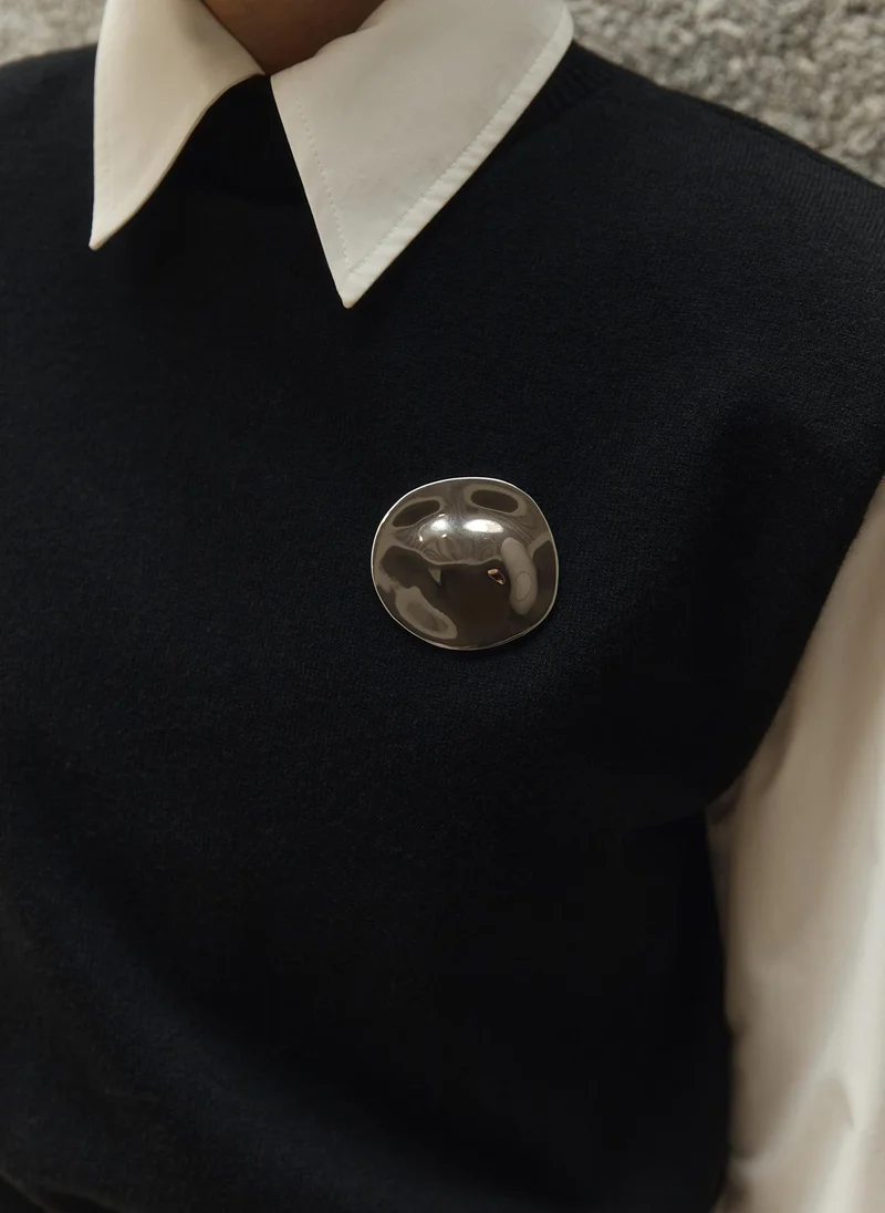 Glossy metal brooch