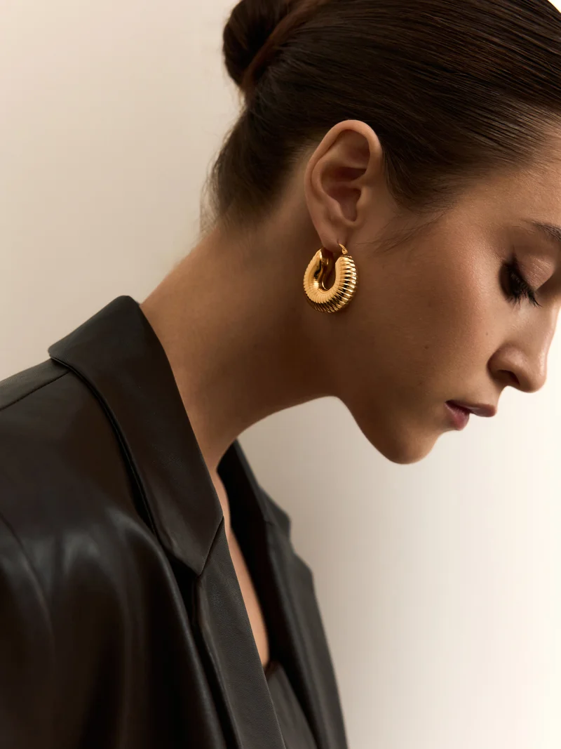Golden half-hoop earrings in textured metal