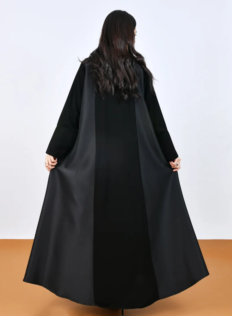 HAWRAA ABAYA Elegant Black Abaya with a classic design featuring front buttons and a half-cloche cut.