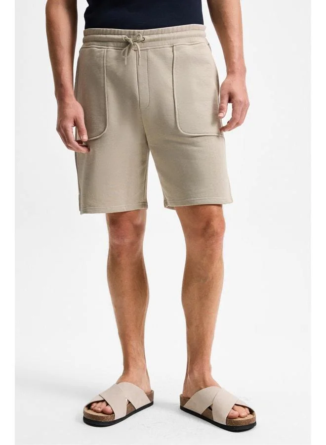 Grimelange GAUCI Men's Elastic Waist, Side and Back Pocket, Relaxed Stone-Colored Shorts.