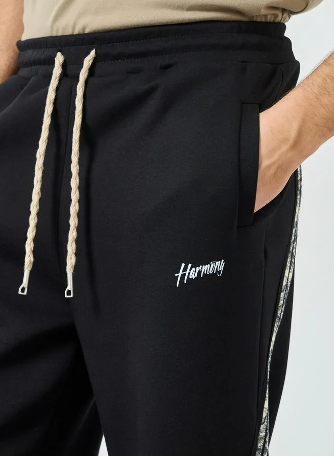Styli  Styli Men Black Side Taping Print Oversized Joggers for Men | Best Price UAE