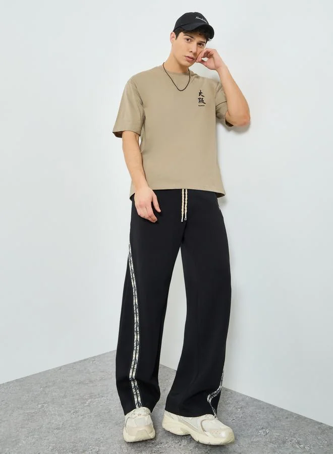ستايلي Styli Men Black Side Taping Print Oversized Joggers