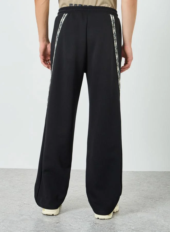 Styli  Styli Men Black Side Taping Print Oversized Joggers for Men | Best Price UAE