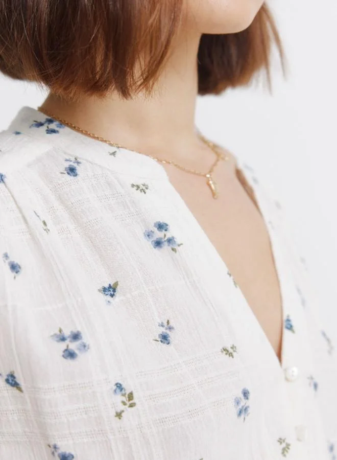 Springfield Long sleeve checked blouse with fringed cuffs, front buttons, open V-neck mandarin collar, and floral print.