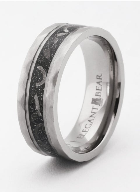 A ring made of titanium in silver color, inlaid with artificial meteorites and silver leaves.