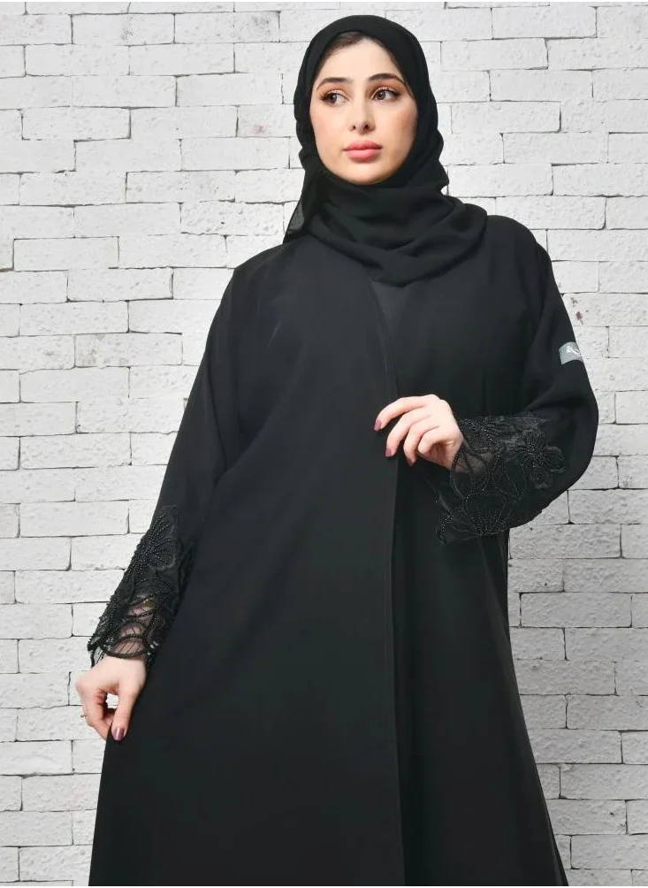 lamha abaya Elegant black wrap abaya with a prominent orchid flower design on the sleeves