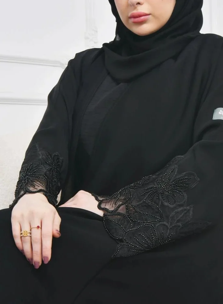 عبايات لمحة عباية لف سوداء راقية بكلفة بارزة على شك وردة الاوركيد على الاكمام