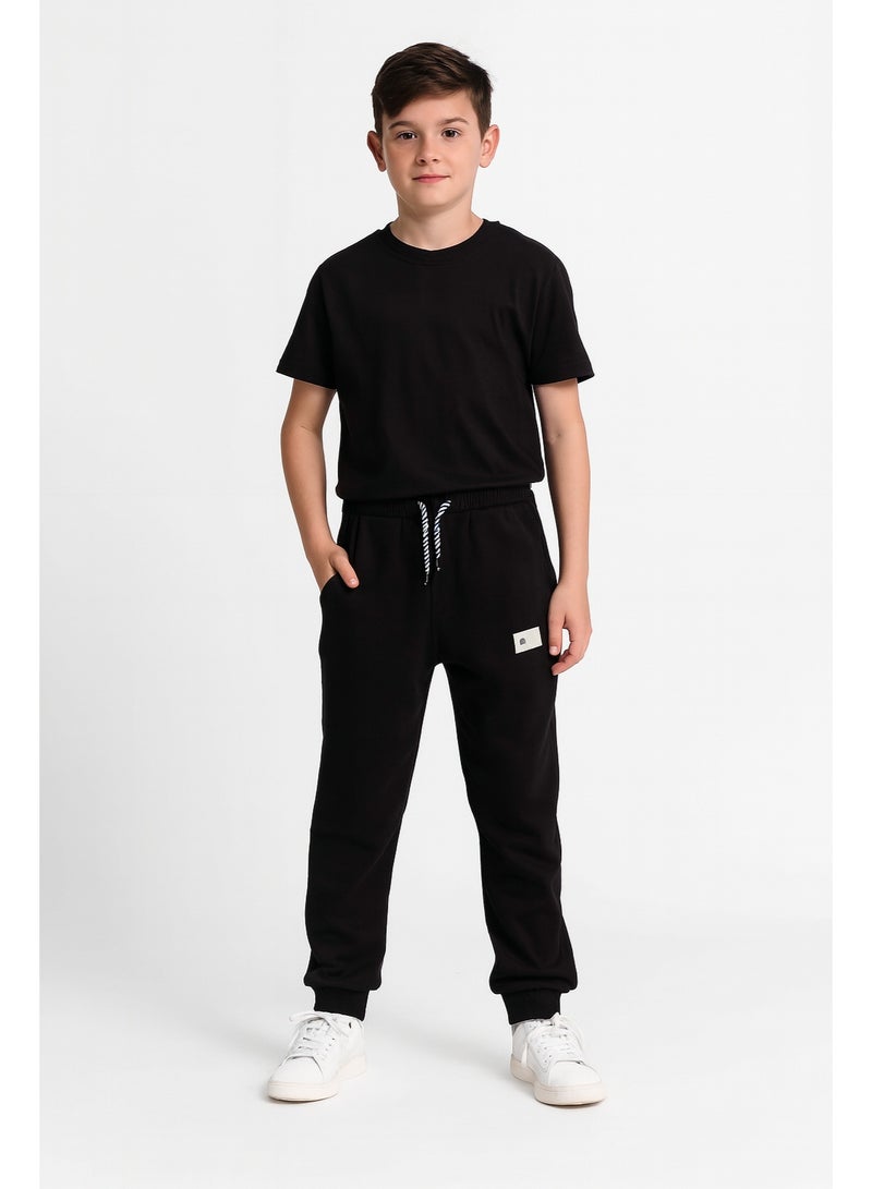 شي إن بنطلون جوجر للأولاد خامة قطن + لايكرا – أسود مقاس 11–12 سنة - Image 1