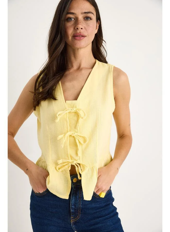 Ginger Bow Tie Up Detail Peplum Top