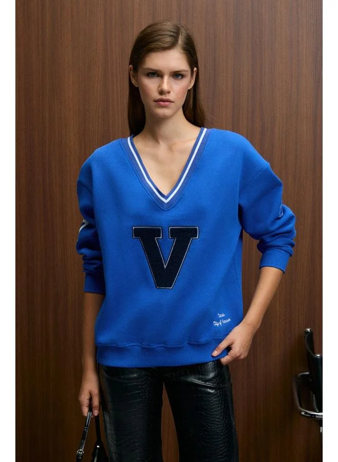 GRIMELANGE DIVINE Women's V-Neck Embroidered and Patch-Detail Blue Sweatshirt.