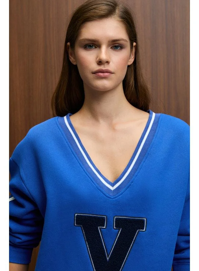 GRIMELANGE DIVINE Women's V-Neck Embroidered and Patch-Detail Blue Sweatshirt.