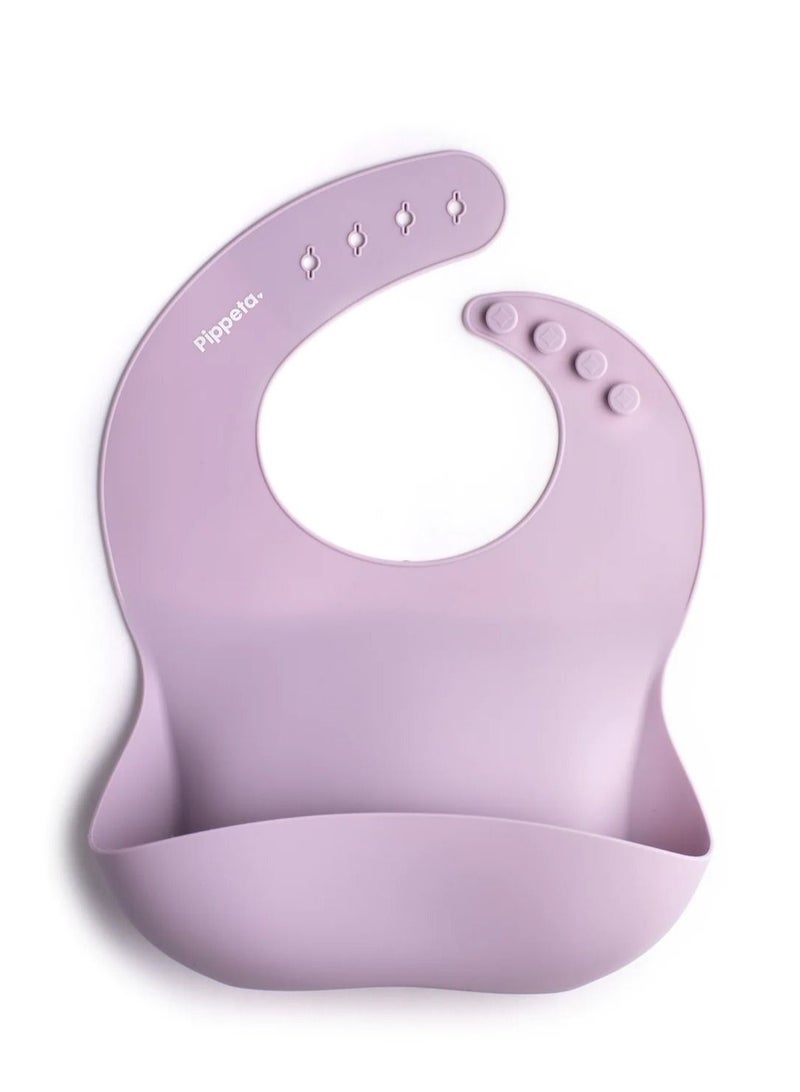Pippeta The Pippeta Silicone Baby Bib is designed to make mealtime cleaner and more convenient for both parents and babies. Made from premium food-grade silicone, it is soft, safe, and completely BPA-free. Its waterproof design helps protect clothing from spills, while the built-in food catcher pocket keeps mess to a minimum. The adjustable neck strap ensures a comfortable fit as your baby grows. Easy to clean, roll, and carry, it is perfect for both home use and travel. A practical everyday essential that combines functionality, durability, and smart design in one feeding solution. - Image 1