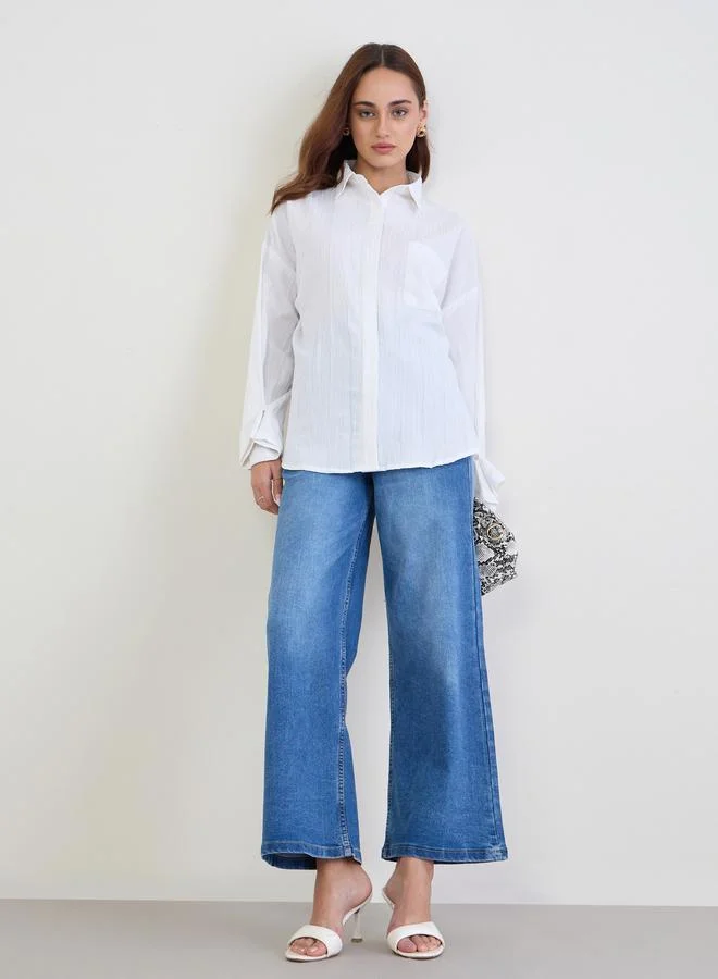 ستايلي بلوزة واسعة بتفاصيل بارزة الملمس مع أكمام بأساور