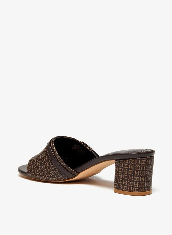 فلورا بيلا من شو إكسبرس Women Monogram Print Slip-On Sandals with Block Heels and Buckle Accent