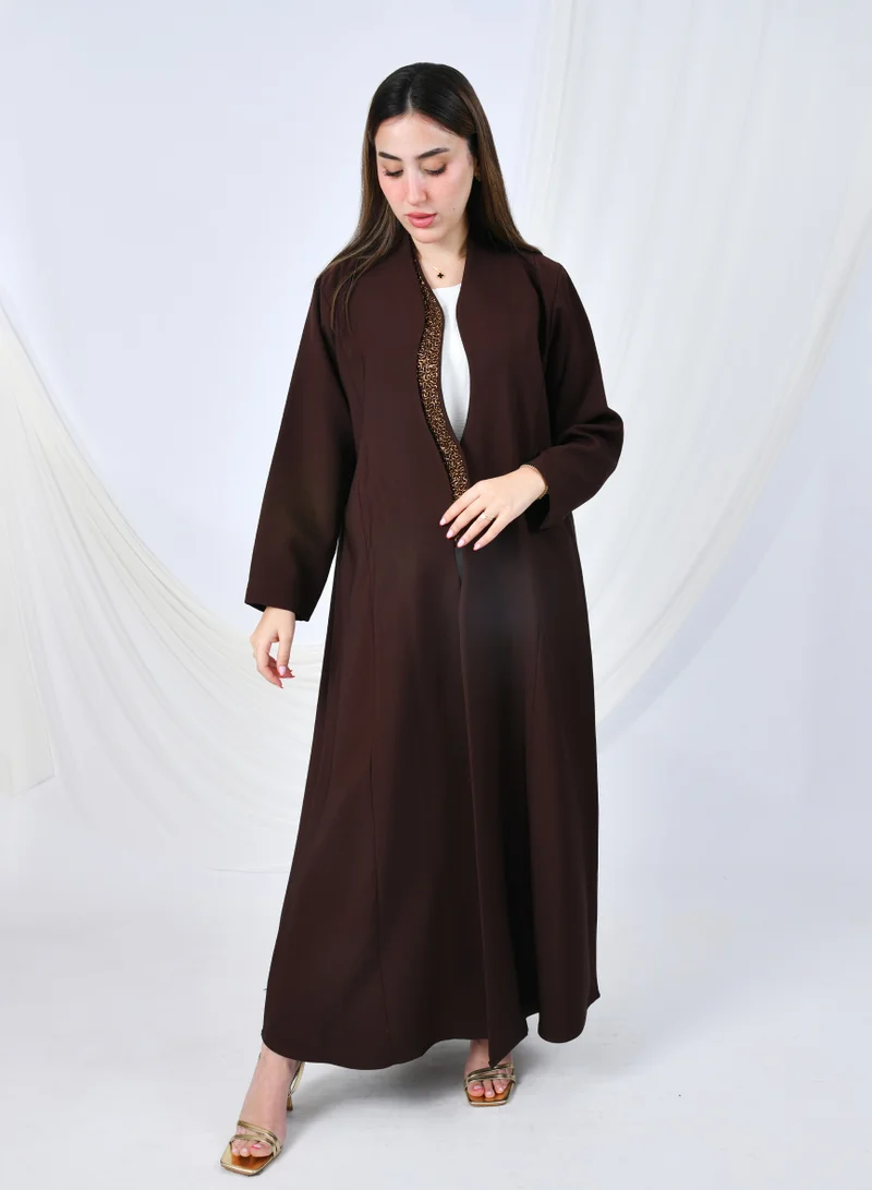 HAWRAA ABAYA An elegant abaya that combines simplicity and luxury with a quarter-length hem embellished with shawl detailing at the front edges | Brown with gold shawl detailing