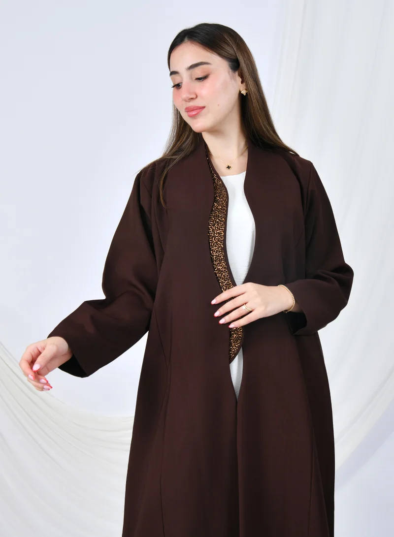 HAWRAA ABAYA An elegant abaya that combines simplicity and luxury with a quarter-length hem embellished with shawl detailing at the front edges | Brown with gold shawl detailing