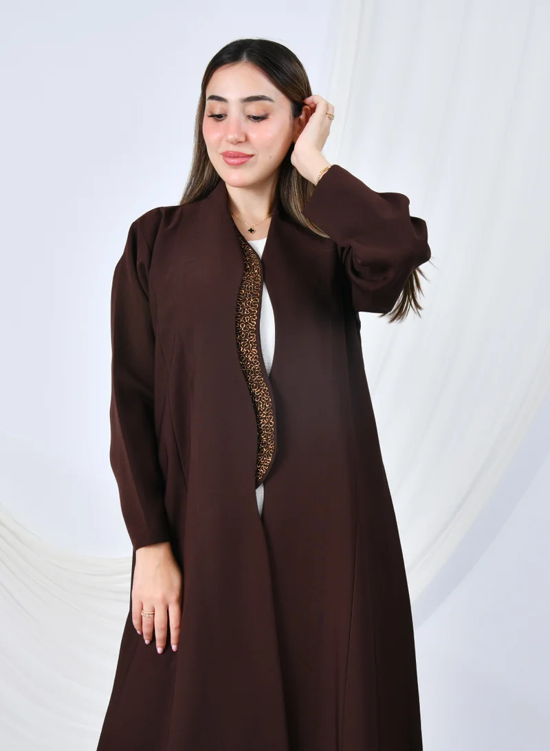 HAWRAA ABAYA An elegant abaya that combines simplicity and luxury with a quarter-length hem embellished with shawl detailing at the front edges | Brown with gold shawl detailing
