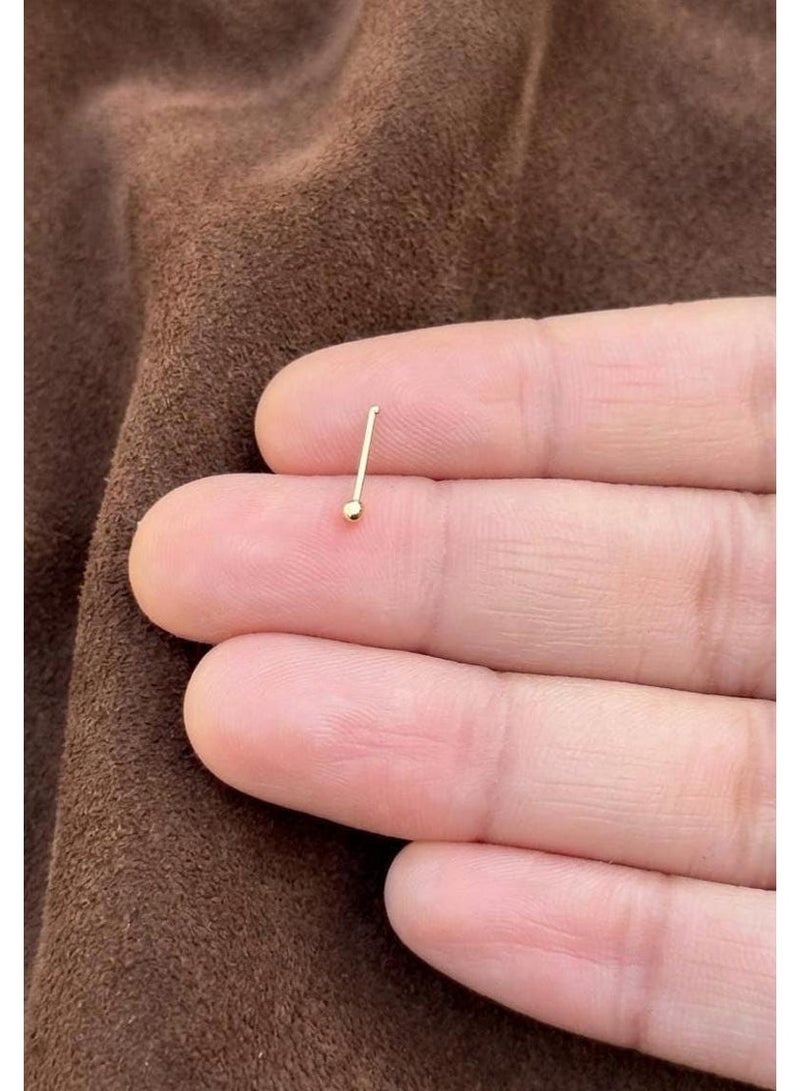Luxuria These gold nose rings for women feature a simple and elegant design. Their small, delicate size creates a subtle yet understated look, while a small gold ball adds a touch of feminine charm. The design is suitable for everyday wear and easily complements various outfits. - Image 5