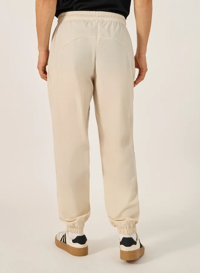 Styli Solid Relaxed Fit Elasticated Cuff Joggers with Contrast Zip detail