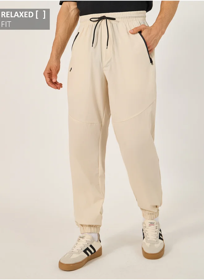 ستايلي Solid Relaxed Fit Elasticated Cuff Joggers with Contrast Zip detail