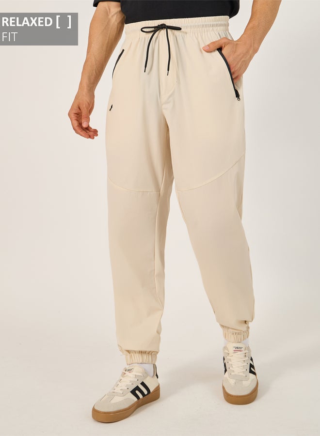 Styli Solid Relaxed Fit Elasticated Cuff Joggers with Contrast Zip detail  - Image 1