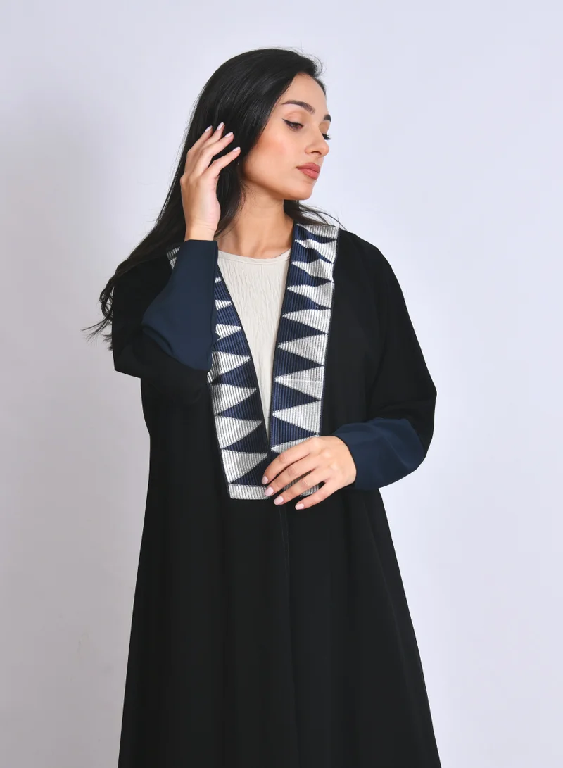 HAWRAA ABAYA Black quarter-cloche abaya with elegant embroidery and navy stretch sleeve details