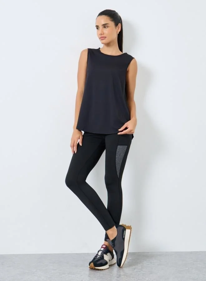 ستايلي اكتيف بلوزة تانك بلا أكمام وقصة سائبة مع تداخلات شبكية