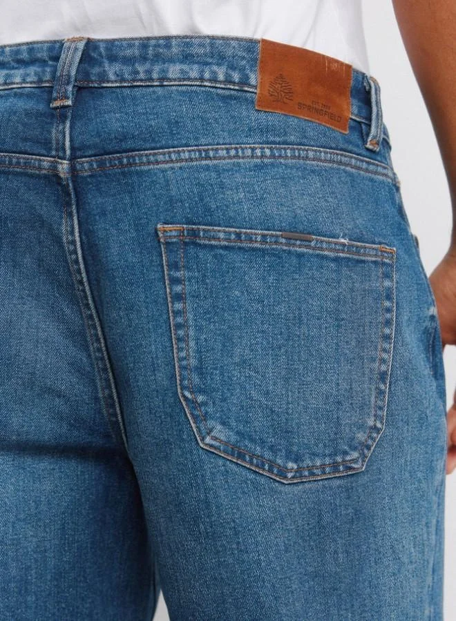 Springfield  Stretch regular fit 5-pocket comfort jeans with two-tone embroidered coin pocket detail, medium-dark wash, overdyed dirty effect, worn look and zip fly fastening. for Men | Best Price UAE
