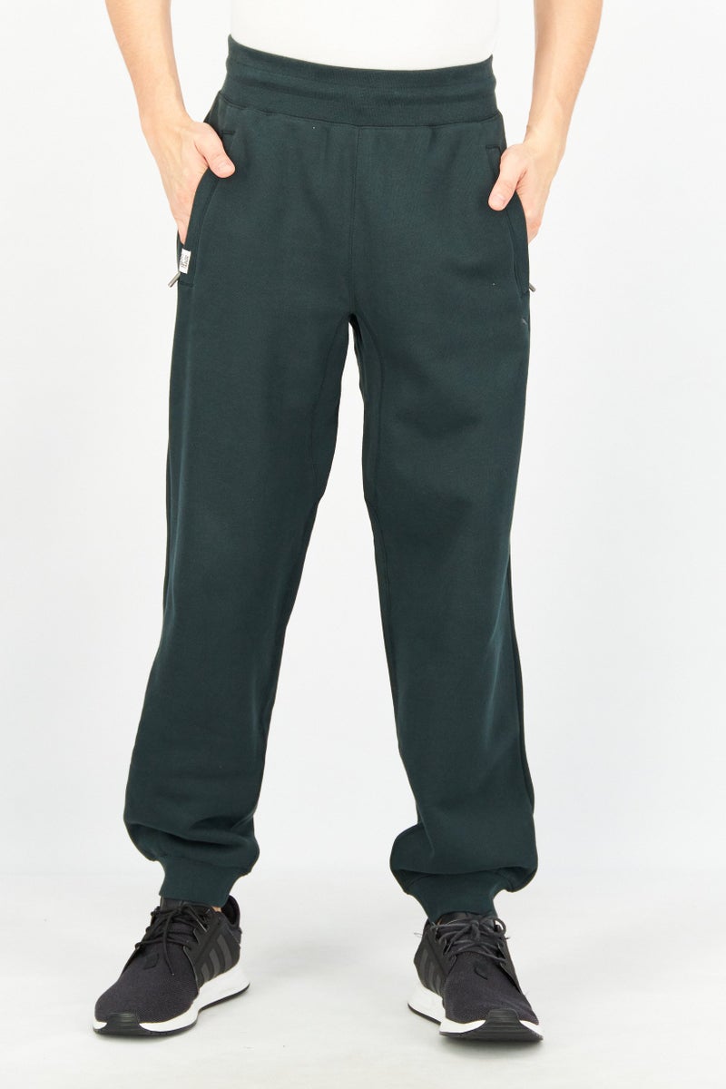 PUMA Men Sportswear Fit Embroidered Logo Training Jogger Pants, Dark Green - Image 1