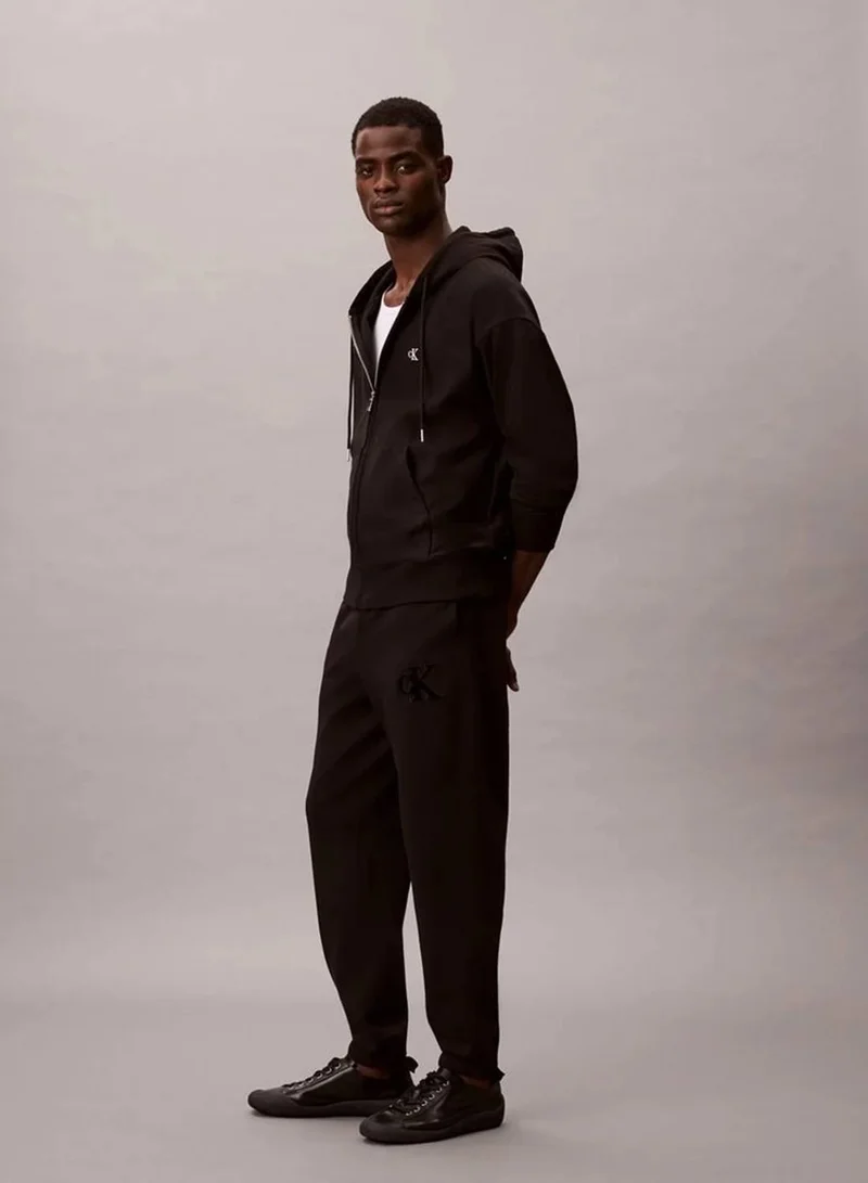 Calvin Klein Jeans Black Fleece Monogram Logo Patch Joggers for Men | Best Price UAE