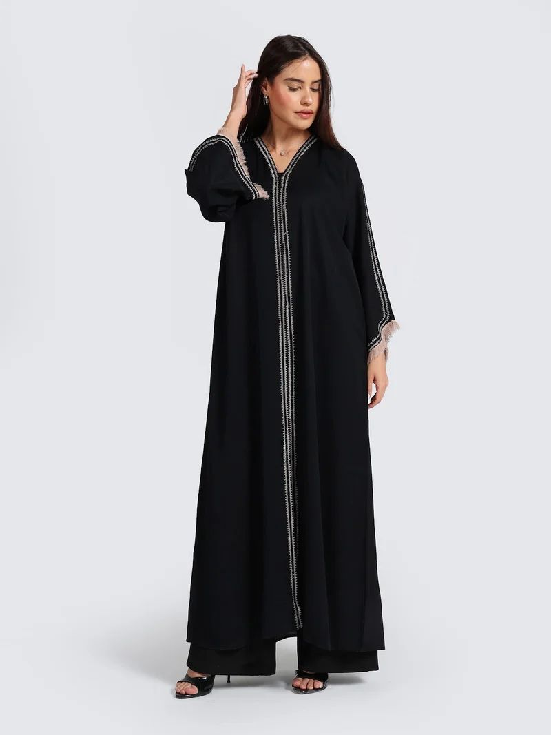 عباءات ريم Sophisticated Black Abaya with White Contrast Stitching & Fringed Cuffs