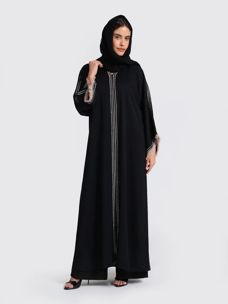 عباءات ريم Sophisticated Black Abaya with White Contrast Stitching & Fringed Cuffs