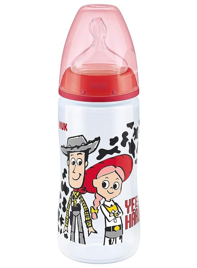 NUK First Choice+ Toy Story Baby Bottle, 6-18 Months, Anti Colic, Silicone Teat, BPA Free, Receive Woody or Buzz (Design Varies), 300 ml - Image 1