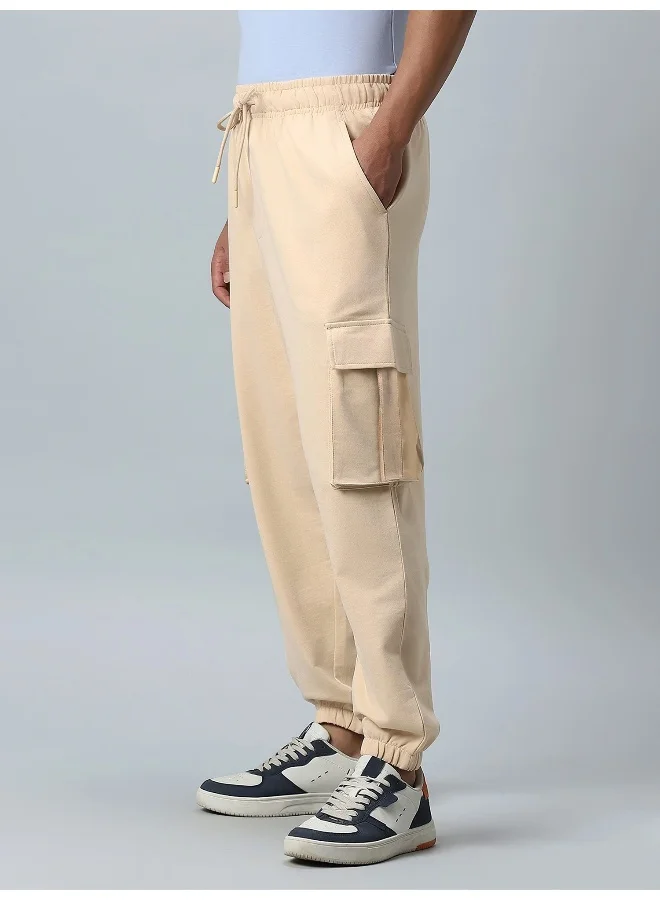 مانياك بنطلون كارجو قطن رجالي بقصة واسعة وجيوب جانبية بلون بيج سادة