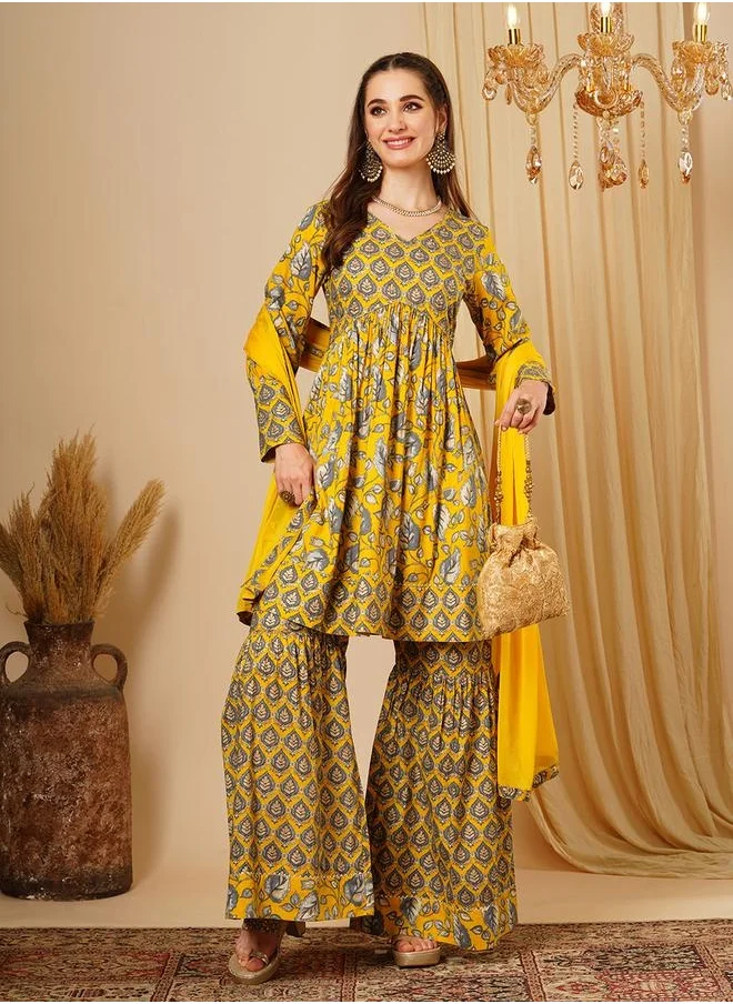 جلو باص Globus Women Mustard Allover Floral Print Alia Cut Knee Length Kurta With Sharara & Dupatta Festive Wear Set by Styli