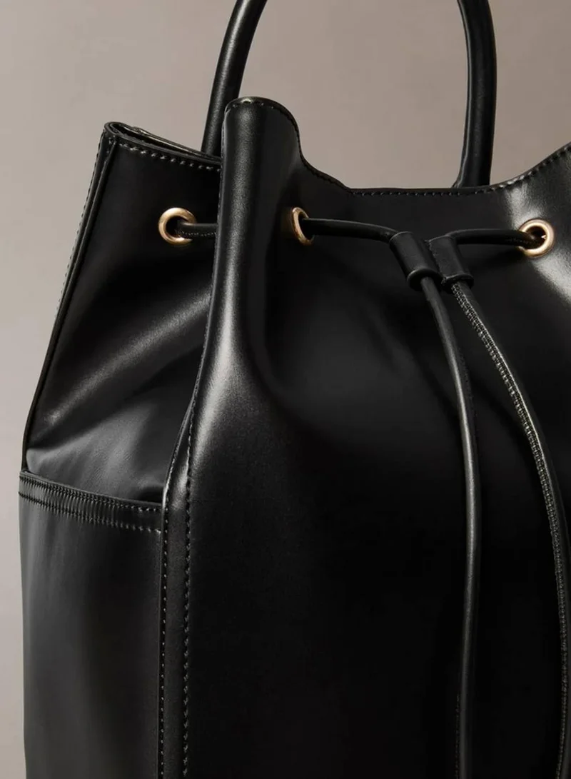 Calvin Klein BLACK / ANTIQUE LIGHT GOLD Monogram Drawstring Backpack for Women | Best Price UAE