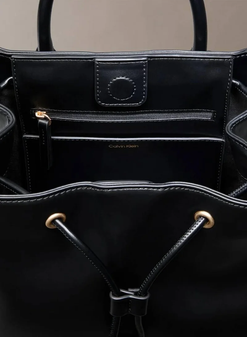 Calvin Klein BLACK / ANTIQUE LIGHT GOLD Monogram Drawstring Backpack for Women | Best Price UAE