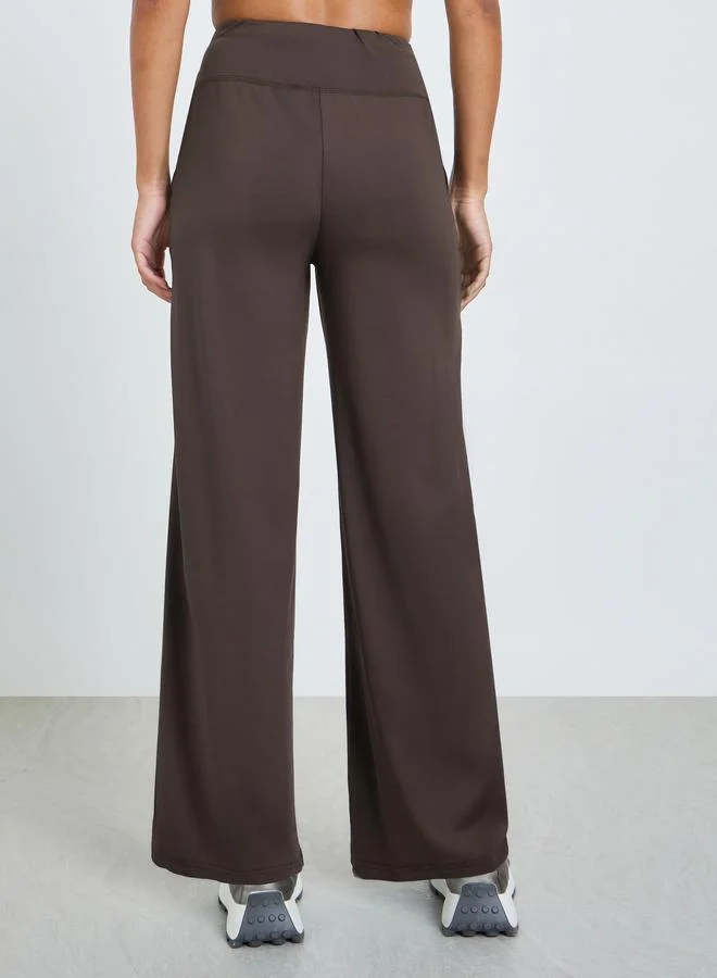 Styli Active  Brown Broad Waist Tie and Pocket Detail Loose Straight Pants for Women | Best Price UAE