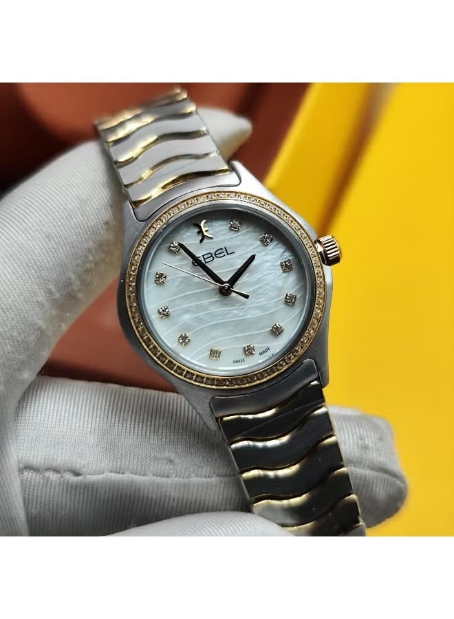 The Ebel women's watch features a classic design with a distinctive wave-shaped strap.