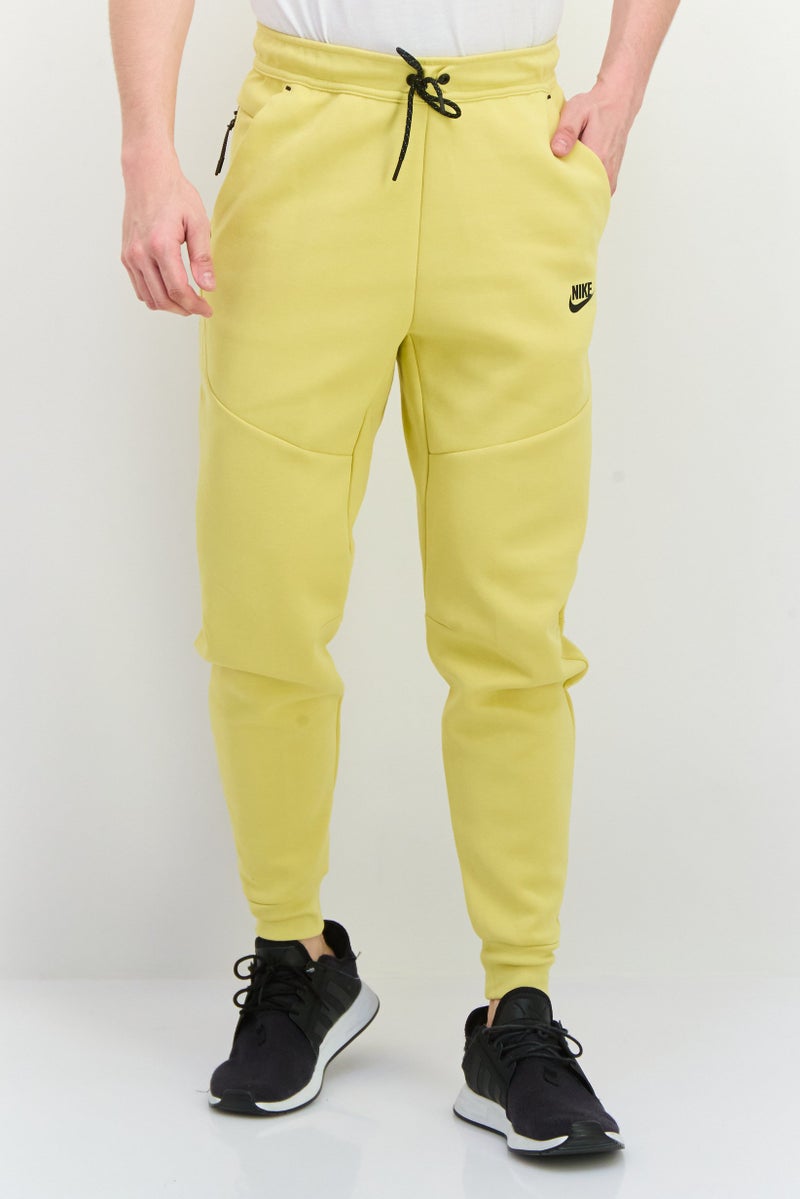 Nike Men Slim Fit Taper Leg Regular Length Training Sweatpants, Yellow - Image 1