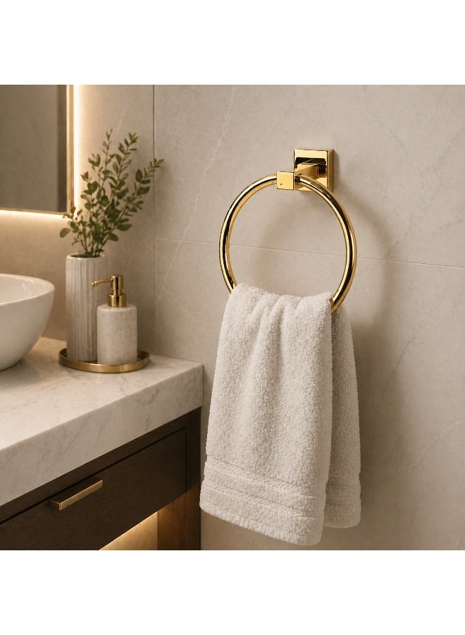 A round, wall-mounted towel rack made of stainless steel in a gold color. - Image 1