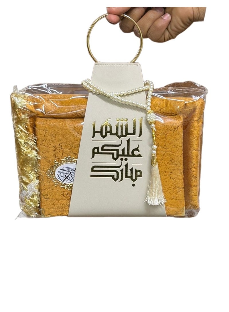 A prayer rug, a Quran, and prayer beads, presented with a suitable strap, as a Ramadan gift. - Image 1