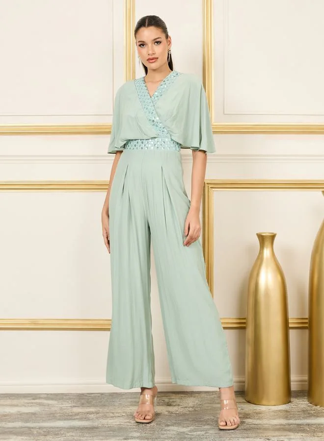 ستايلي Embellished Cape Sleeves Wide Leg Jumpsuit