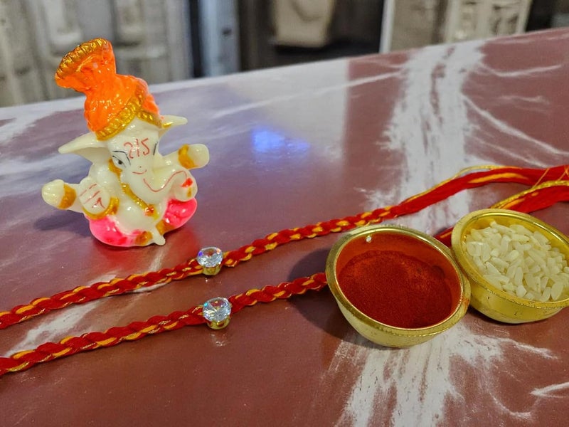 Evisha 2 pcs Simple Elegant Moli Thread with Stone Rakhi with Ganesh Murti for Brother Men Bhaiya R-64-Two Rakhi with Roli Chawal Packet Rakhi for bhai - Image 5