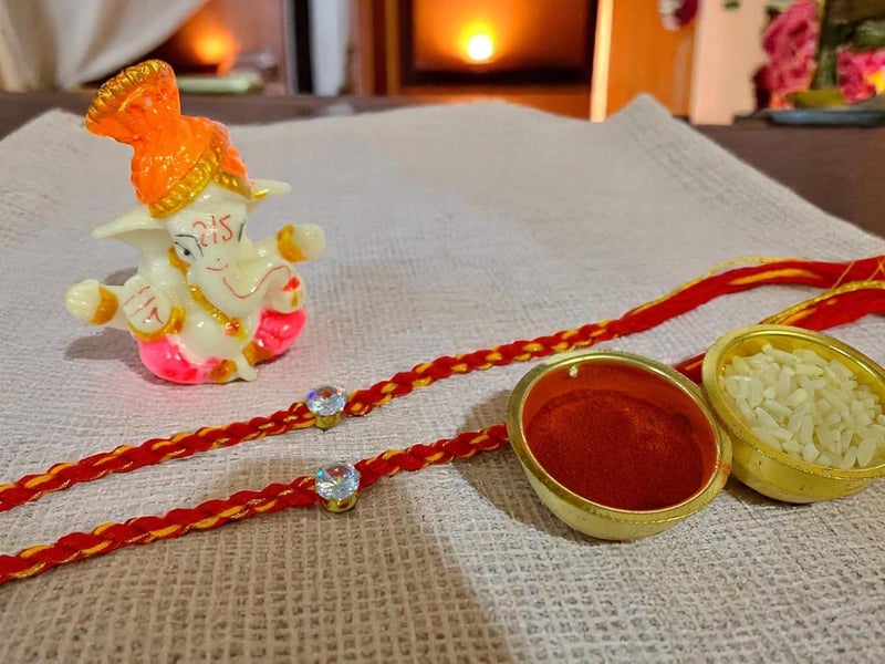 Evisha 2 pcs Simple Elegant Moli Thread with Stone Rakhi with Ganesh Murti for Brother Men Bhaiya R-64-Two Rakhi with Roli Chawal Packet Rakhi for bhai - Image 4