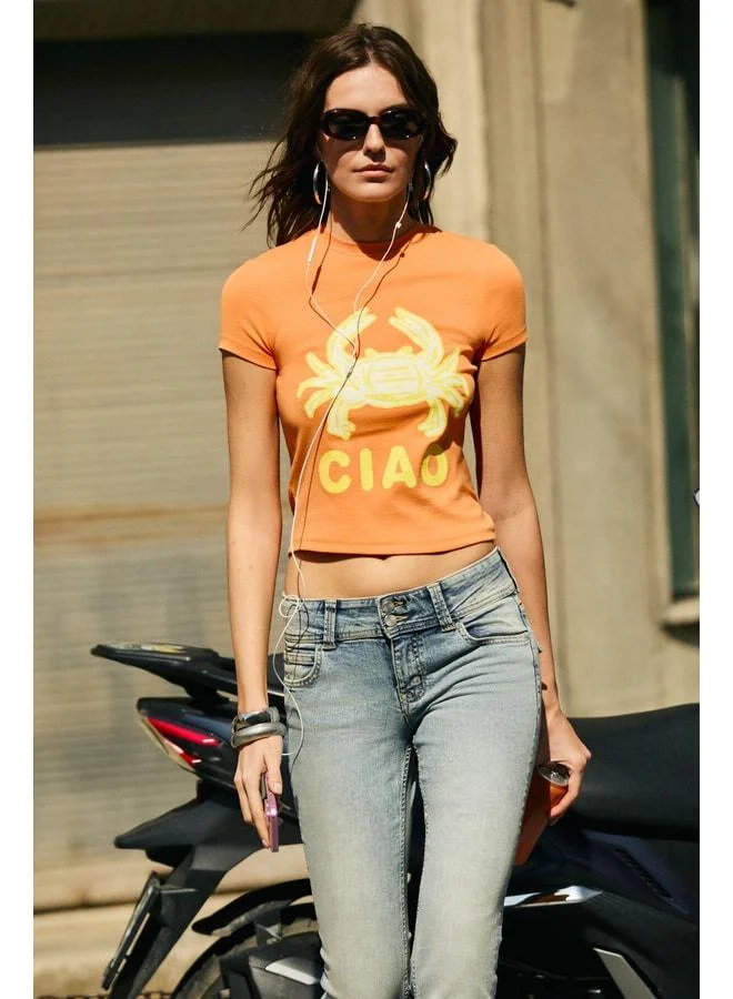 Grimelange MECHELAN Women's Soft and Flexible Printed Round Neck Short Sleeve Orange T-Shirt.