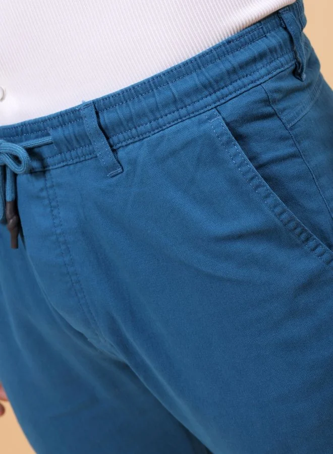 شركة المرآب الهندية Men Slim Fit Solid Mid-Rise Elasticated Linen Jogger Trouser