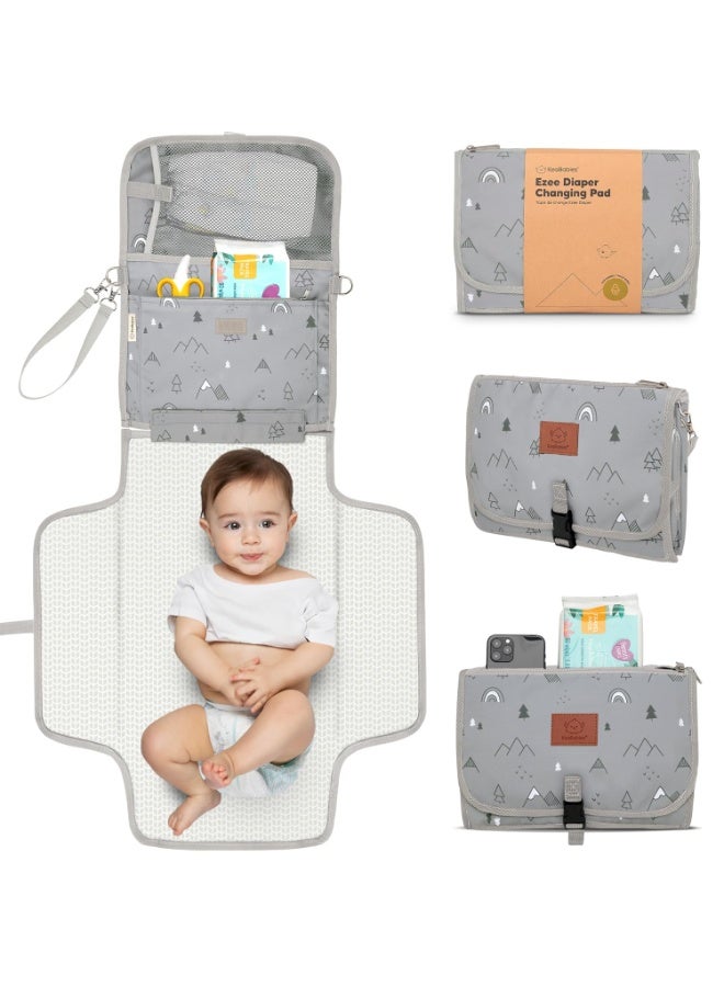 KeaBabies Portable Diaper Changing Pad - Large Waterproof Baby Changing Mat, Compact Travel Diaper Clutch, Functional Pockets Fit Newborn Essentials, Wipeable & Padded Baby Changer (Woodland) - Image 1