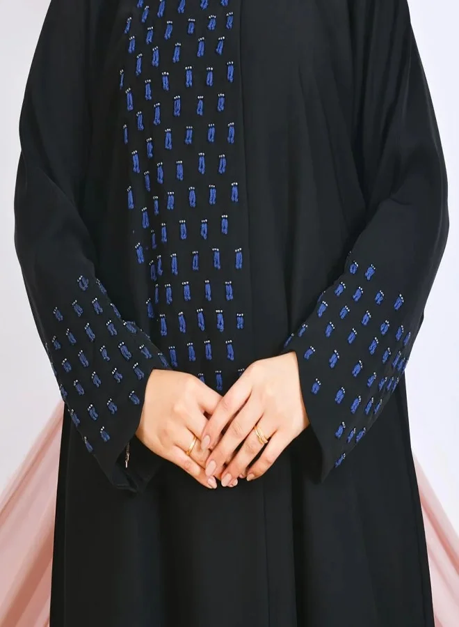 lamha abaya Black closed abaya with snap buttons, adorned with prominent navy blue embroidery